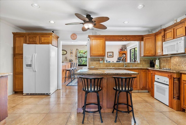 12610 63rd Ln N, The Acreage, FL 33412 - kitchen featuring decorative backsplash, a healthy amount of sunlight, and white appliances