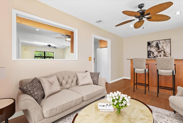 12610 63rd Ln N, The Acreage, FL 33412 - living room featuring visible vents, a ceiling fan, baseboards, and wood finished floors