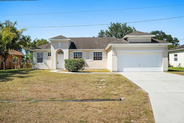565 SW Feldman Ave N, Port Saint Lucie, FL 34953 - single story home featuring roof with shingles, an attached garage, stucco siding, a front yard, and driveway