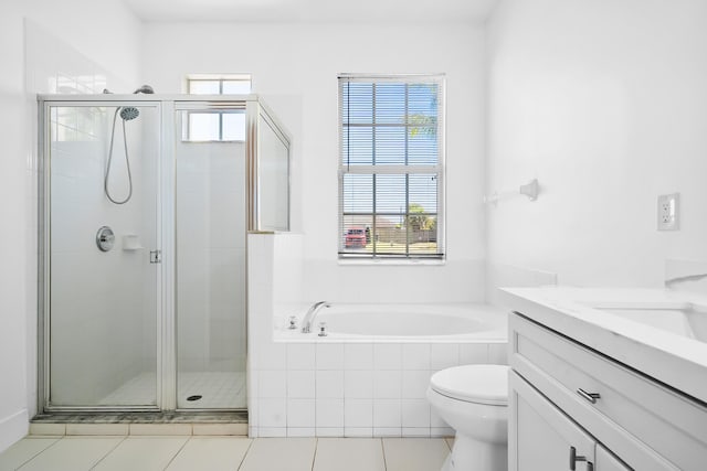 565 SW Feldman Ave N, Port Saint Lucie, FL 34953 - full bathroom featuring tile patterned flooring, vanity, toilet, a bath, and a stall shower