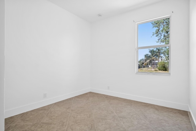 565 SW Feldman Ave N, Port Saint Lucie, FL 34953 - empty room with light tile patterned flooring and baseboards