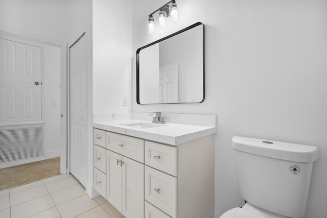 565 SW Feldman Ave N, Port Saint Lucie, FL 34953 - bathroom with toilet, tile patterned floors, visible vents, and vanity