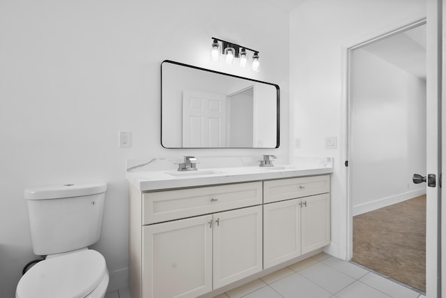 565 SW Feldman Ave N, Port Saint Lucie, FL 34953 - full bath featuring double vanity, a sink, tile patterned floors, and toilet