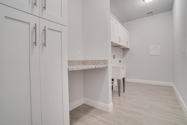 1634 SW Import Dr, Port Saint Lucie, FL 34953 - washroom with washer hookup, baseboards, electric dryer hookup, and visible vents