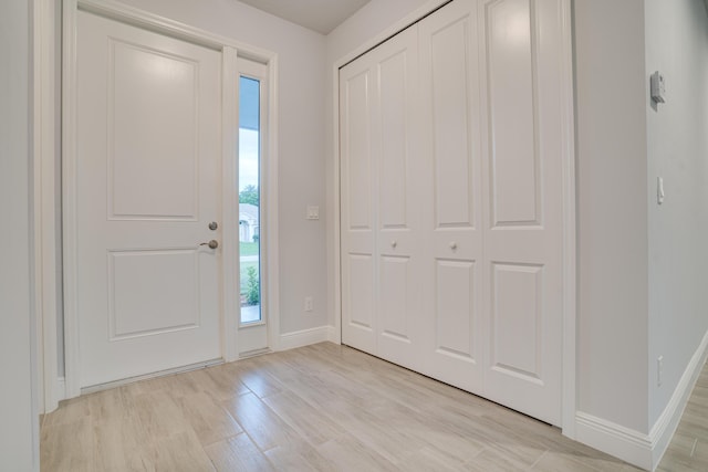 1634 SW Import Dr, Port Saint Lucie, FL 34953 - foyer entrance featuring baseboards and light wood finished floors