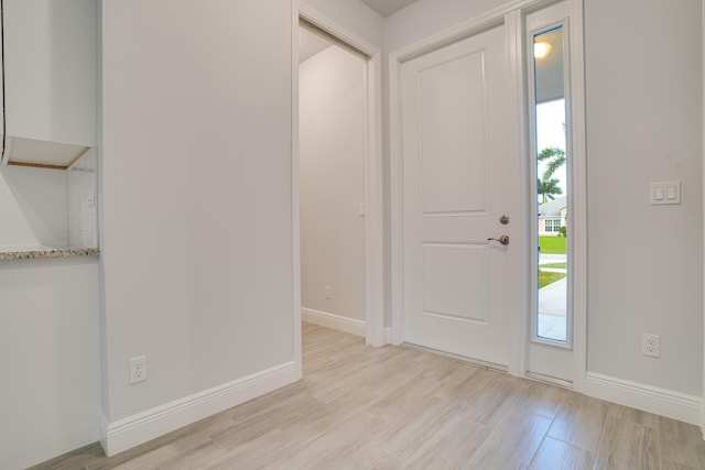 1634 SW Import Dr, Port Saint Lucie, FL 34953 - entryway with baseboards and light wood-style floors