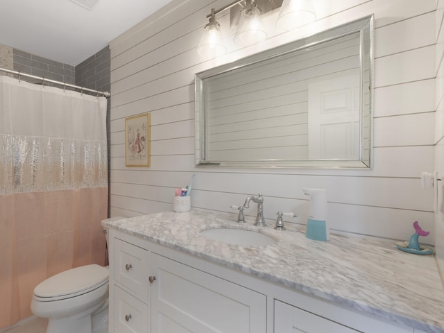 full bathroom featuring wooden walls, toilet, curtained shower, and vanity