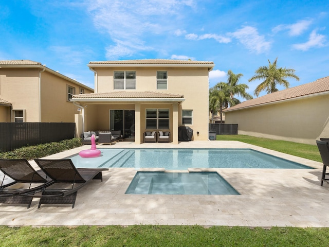 back of house with an in ground hot tub, a tile roof, a fenced in pool, an outdoor hangout area, and stucco siding