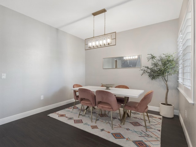 dining area with baseboards and wood finished floors