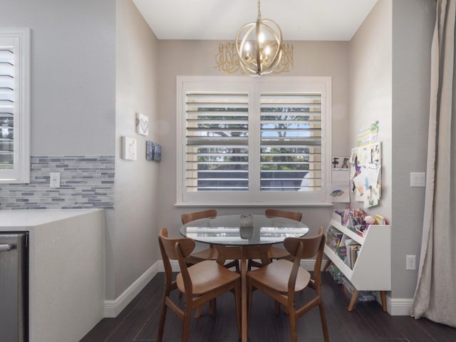 dining room featuring baseboards, dark wood-style flooring, and a notable chandelier