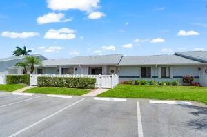 2641 Gately Dr W Unit 103, West Palm Beach, FL 33415 - ranch-style home featuring fence private yard, a gate, uncovered parking, and a front yard