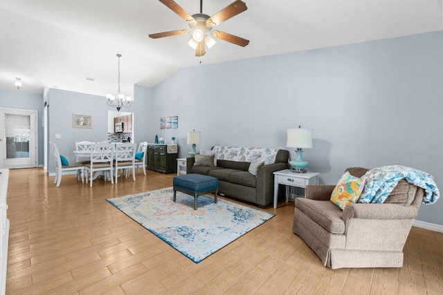 2641 Gately Dr W Unit 103, West Palm Beach, FL 33415 - living area featuring baseboards, lofted ceiling, ceiling fan with notable chandelier, and light wood-style floors