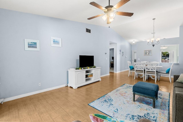 2641 Gately Dr W Unit 103, West Palm Beach, FL 33415 - living room featuring visible vents, wood finished floors, baseboards, ceiling fan with notable chandelier, and lofted ceiling