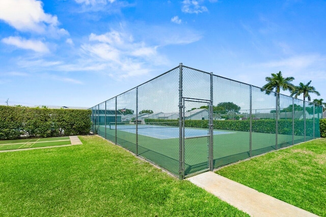 2641 Gately Dr W Unit 103, West Palm Beach, FL 33415 - view of sport court featuring fence and a yard