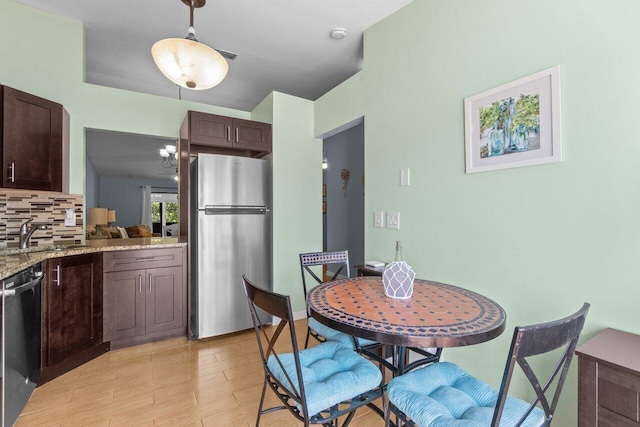 2641 Gately Dr W Unit 103, West Palm Beach, FL 33415 - dining area with light wood-style floors