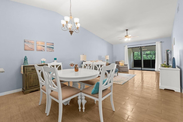 2641 Gately Dr W Unit 103, West Palm Beach, FL 33415 - dining space featuring baseboards, light wood-style flooring, ceiling fan with notable chandelier, and vaulted ceiling