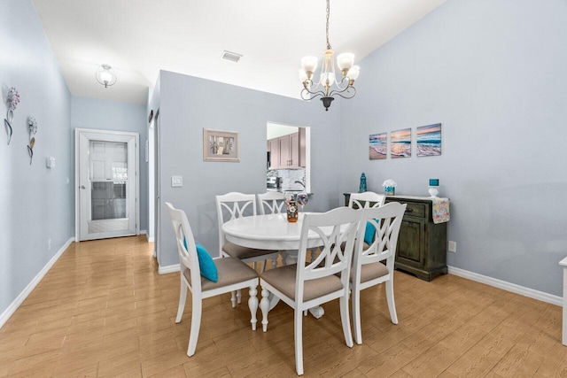 2641 Gately Dr W Unit 103, West Palm Beach, FL 33415 - dining area with visible vents, light wood-style floors, baseboards, and a notable chandelier