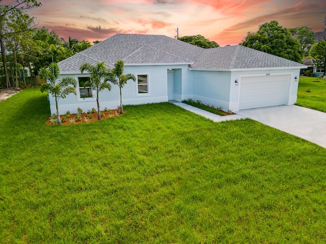 206 SW Voltair Ter, Port Saint Lucie, FL 34984 - ranch-style house with a garage, stucco siding, a shingled roof, concrete driveway, and a yard