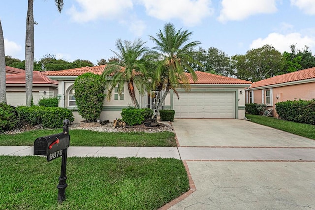 mediterranean / spanish home featuring a garage, a front lawn, stucco siding, a tiled roof, and concrete driveway