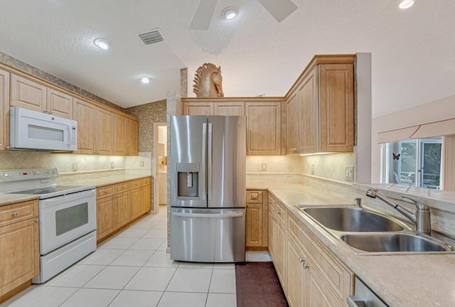 kitchen featuring visible vents, light countertops, a sink, backsplash, and stainless steel appliances