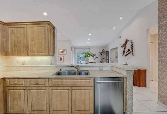 kitchen with a sink, light countertops, a peninsula, tasteful backsplash, and stainless steel dishwasher
