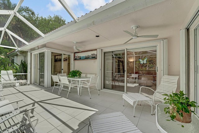 wooden deck featuring a lanai, a ceiling fan, outdoor dining space, and a patio area