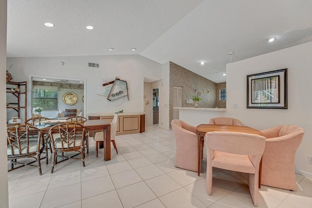 dining room featuring a textured ceiling, recessed lighting, light tile patterned floors, lofted ceiling, and visible vents