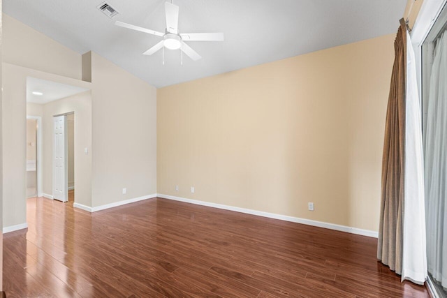 unfurnished room featuring ceiling fan, baseboards, vaulted ceiling, dark wood-type flooring, and visible vents