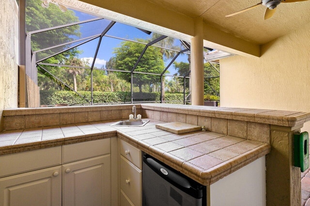 view of patio with area for grilling, ceiling fan, a lanai, and a sink
