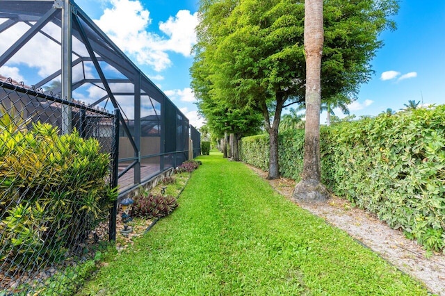 view of yard with glass enclosure