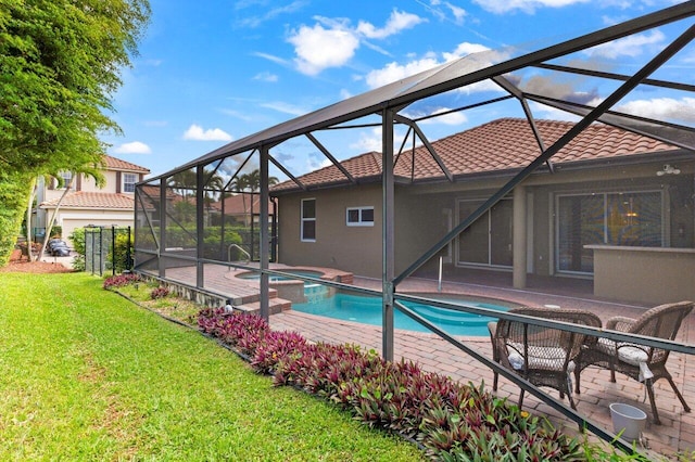 view of swimming pool with a patio area, a lanai, a yard, and a pool with connected hot tub