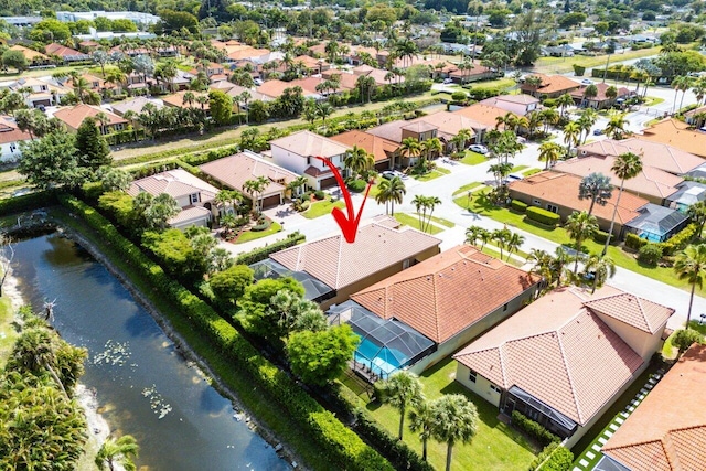 bird's eye view featuring a water view and a residential view