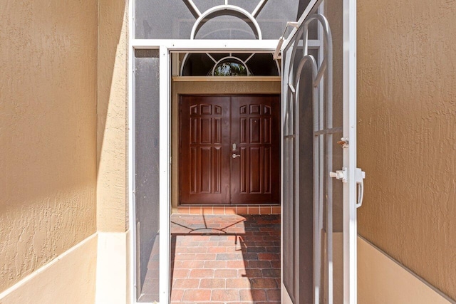 doorway to property with stucco siding