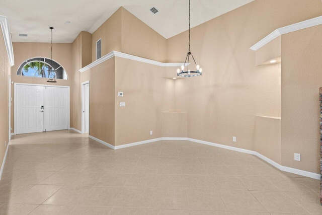 foyer entrance featuring visible vents, high vaulted ceiling, a notable chandelier, and tile patterned flooring