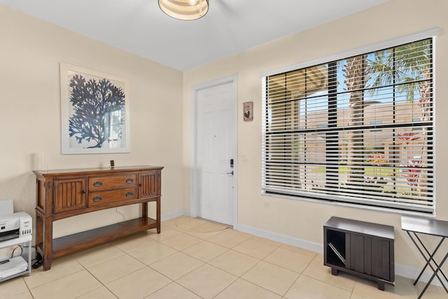 entrance foyer featuring a healthy amount of sunlight, baseboards, and light tile patterned floors