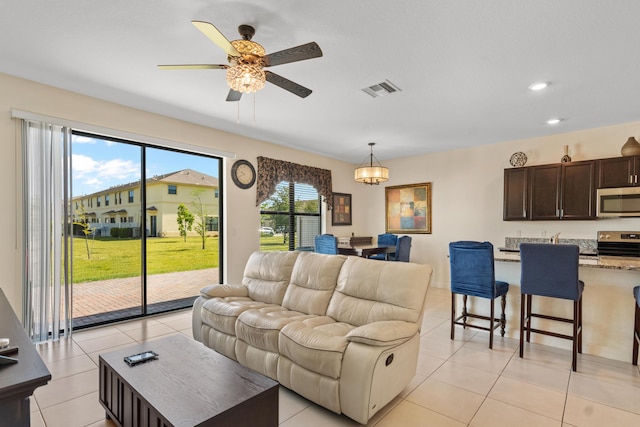 living area with visible vents, a ceiling fan, light tile patterned floors, and recessed lighting