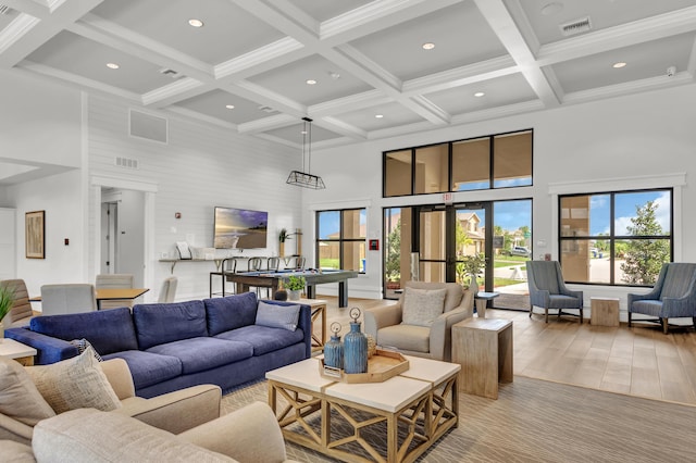 living room featuring visible vents, coffered ceiling, recessed lighting, and a towering ceiling