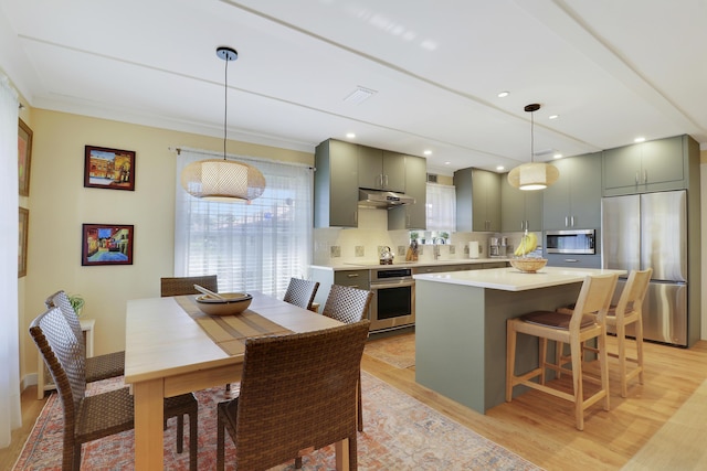 dining room featuring light wood-type flooring and visible vents