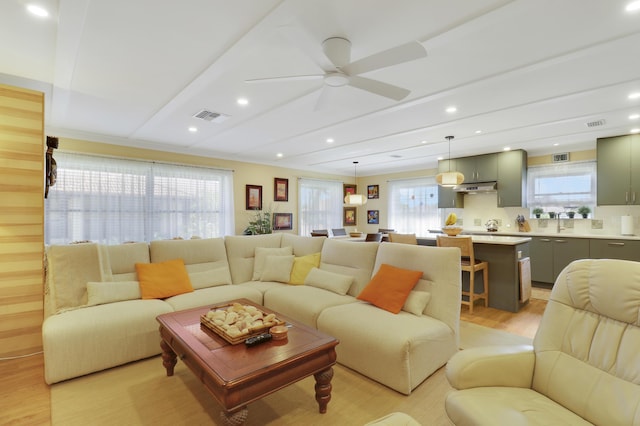 671 SW S River Dr Unit 207, Stuart, FL 34997 - living area featuring light wood finished floors, plenty of natural light, ceiling fan, and recessed lighting