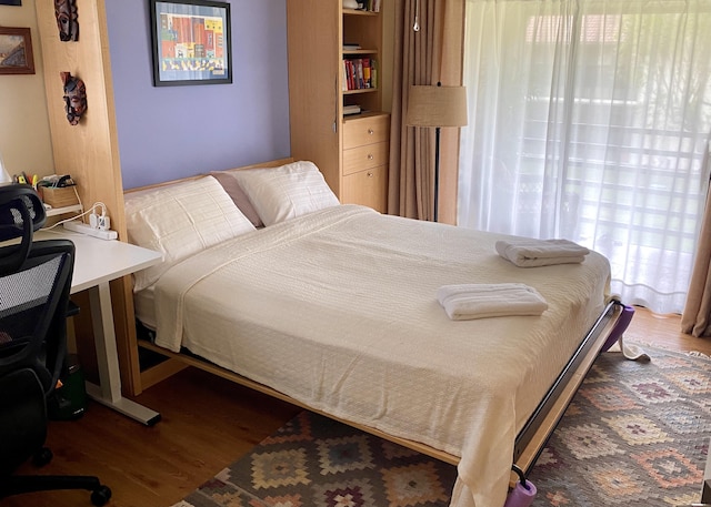 bedroom with wood finished floors