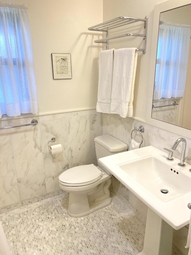 671 SW S River Dr Unit 207, Stuart, FL 34997 - half bathroom featuring tile walls and a wainscoted wall