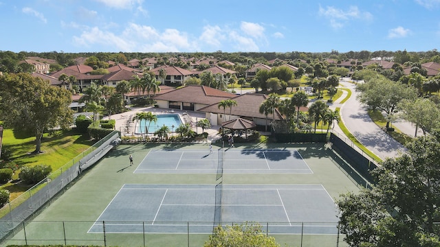 view of sport court with fence and a residential view