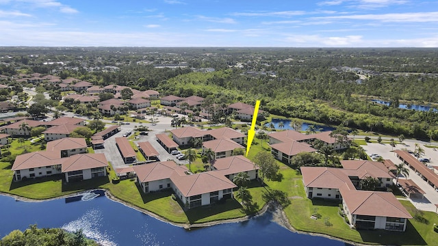 drone / aerial view featuring a water view and a residential view