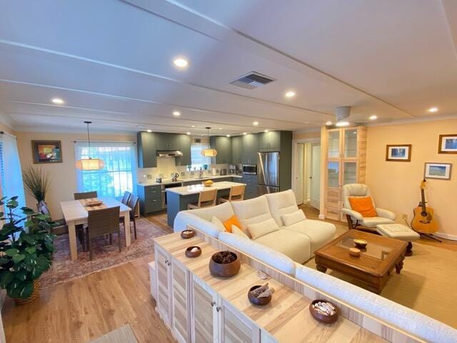 671 SW S River Dr Unit 207, Stuart, FL 34997 - living room featuring light wood-type flooring and recessed lighting
