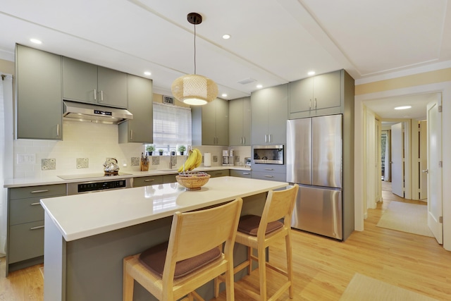 kitchen featuring decorative backsplash, gray cabinets, appliances with stainless steel finishes, and under cabinet range hood