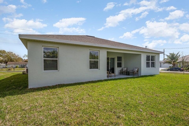 2372 SW Lejune St, Port Saint Lucie, FL 34953 - rear view of property with a patio, a lawn, and stucco siding