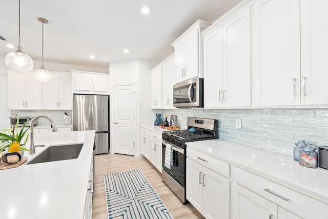 14175 SW Harker St, Port Saint Lucie, FL 34987 - kitchen with stainless steel appliances, a sink, decorative backsplash, recessed lighting, and white cabinets
