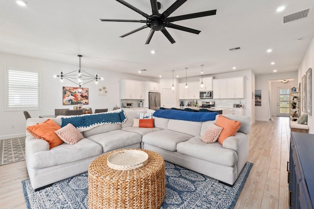 14175 SW Harker St, Port Saint Lucie, FL 34987 - living area with baseboards, a chandelier, light wood finished floors, ceiling fan, and recessed lighting