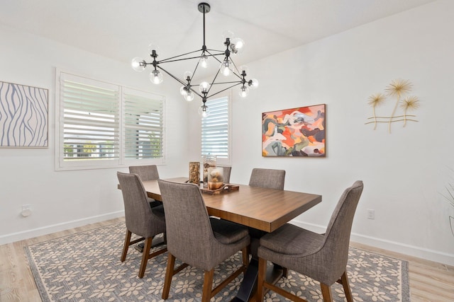 14175 SW Harker St, Port Saint Lucie, FL 34987 - dining space with a chandelier, light wood finished floors, and baseboards