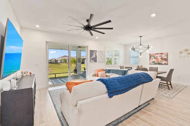 14175 SW Harker St, Port Saint Lucie, FL 34987 - living area with a chandelier, light wood-style floors, recessed lighting, ceiling fan, and baseboards